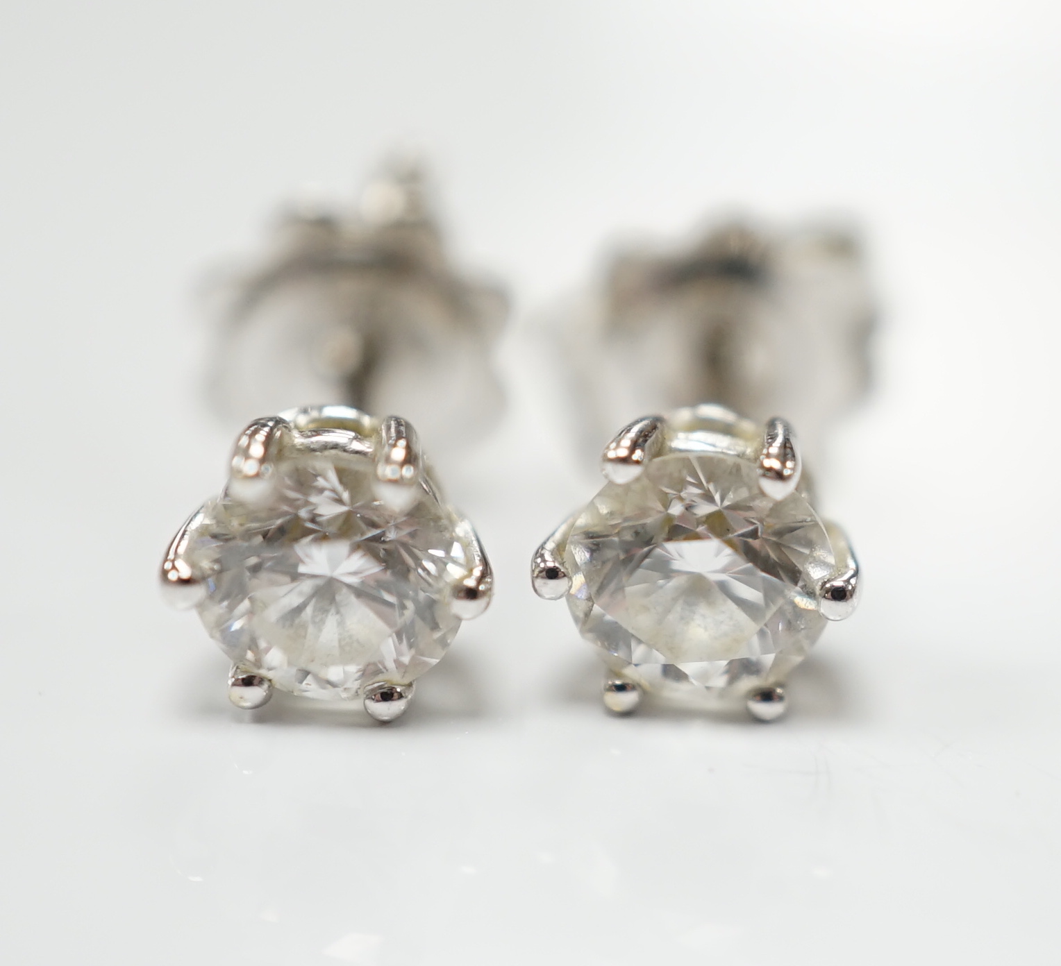 A pair of 18ct white gold and solitaire diamond set ear studs
